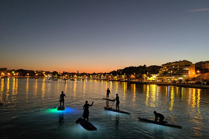 Glowing Stand-Up Paddle Experience in Split - The paddle back: Stobreč white rocks and cliffs at night