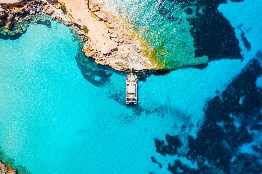 Ibiza: Beach Hopping Cruise w/ Paddleboard, Food, & Drinks - Cala Bassa: the first dock stop where you’ll want your swimsuit on
