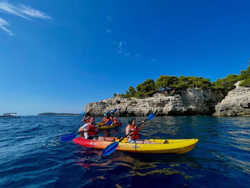 Pula: Cave, Canyon and Island Kayak Tour Snorkel&Explore - Paddling toward Pula Canyon: views plus a steady effort
