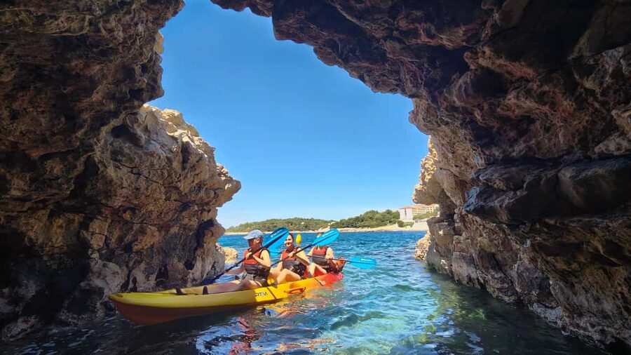Pula: Cave Kayak Tour, Snorkeling and Island Jumping - Kayaking Through Pula’s Cave: pigeons, tight space, and timing