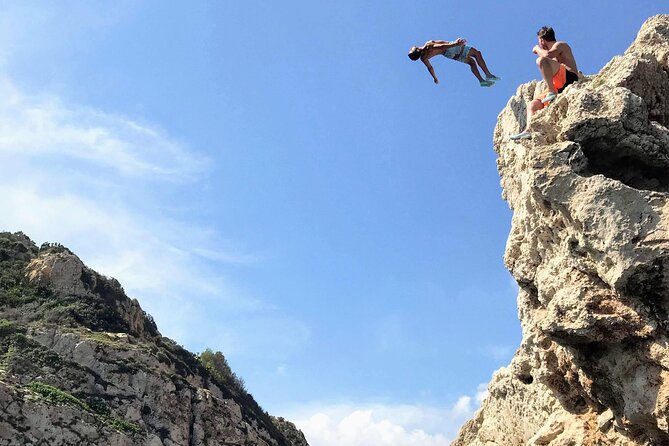 Uncharted Marine Reserve Cave, Snorkel & Cliff Jumping Kayak Tour - Cala Tango cliff jumping: slanted rock, clear options, and real thrills